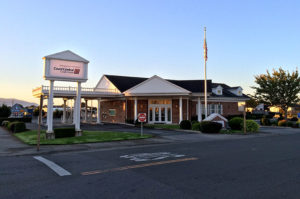 street level view of credit union building and parking lot