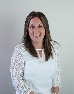 close up of smiling woman in white blouse