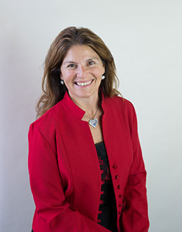 close up of smiling woman in red blazer