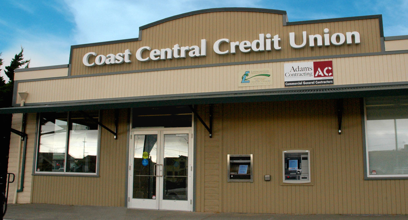 close up of credit union building with front doors and atms