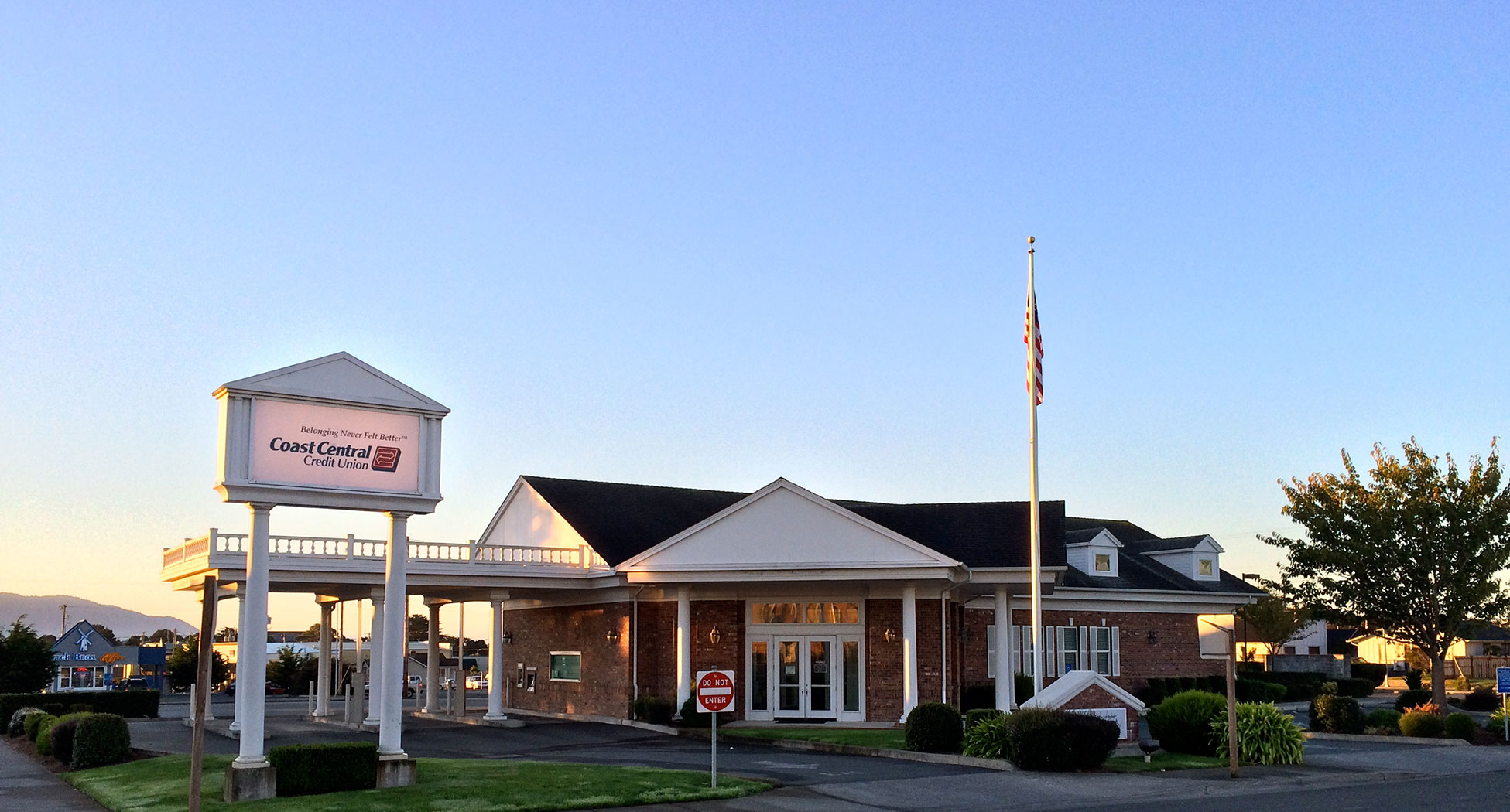 ground level shot of bank building with flag out front