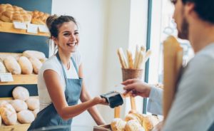 Customer is buying bread with his credit card. We've teamed up with Eureka Payments to provide you with local payment processing!