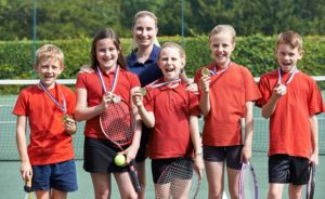 Portrait Of Winning School Tennis Team Smiling With Medals
