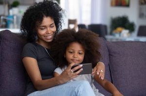Mom and child watching a video together on a cell phone