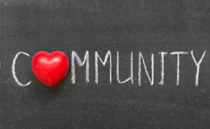 Community spelled out on a chalkboard with a heart