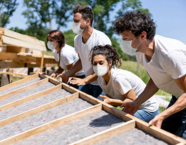 Photo Group of volunteers building a house