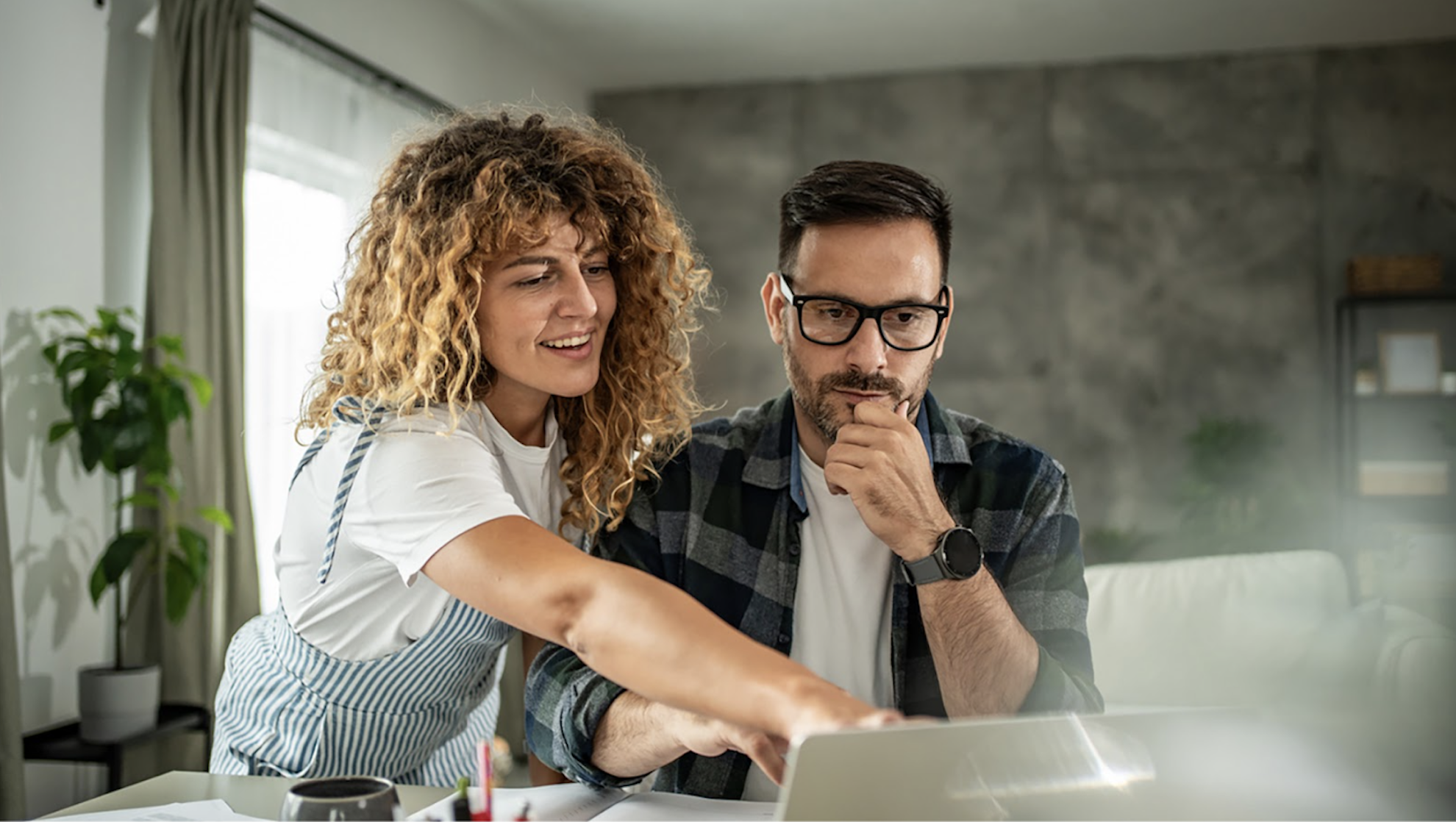 A man and a women looking at a computer