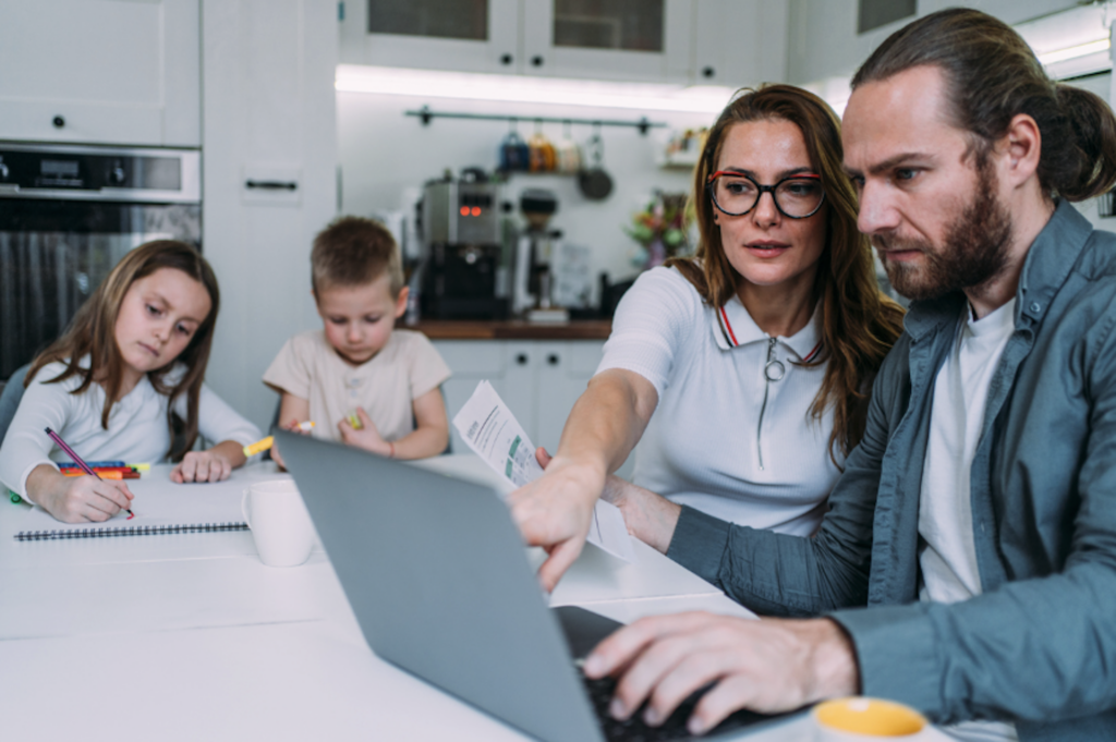 Two parents apply for a personal loan on a laptop