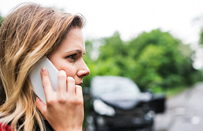 woman on phone after auto accident